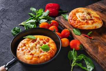 .Pizza in a pan with pizza on a wooden tray