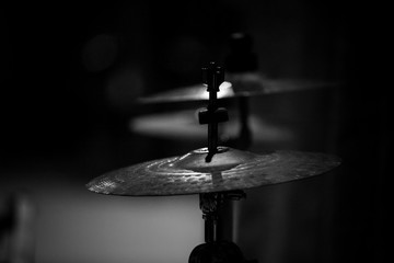  cymbals from a drum kit on stage under stage light against a background of light, ethnic music,...
