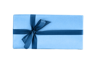 Wrapped gift box with blue ribbon isolated over white background. Color of the year 2020 classic blue toned.
