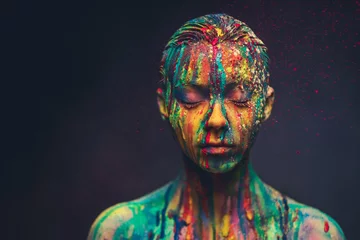  Young woman covered with a colourful paint © Nejron Photo