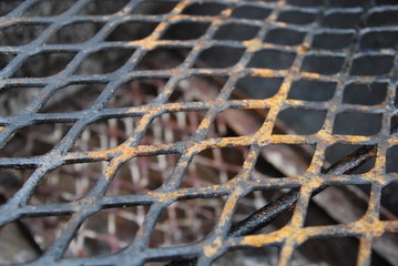 closeup of burnt metal grill pattern