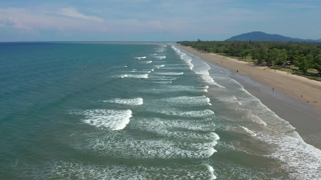 4K Aerial footage view of ocean waves crashing on Beautiful beach by at Sabandar Beach, Tuaran, Sabah, Malaysia
