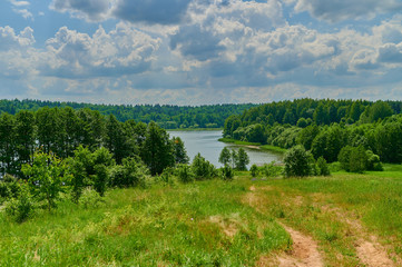 Peaceful rural summer european landscape with green trees and water