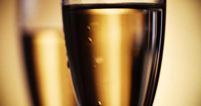 Champagne is poured into the glasses. Slow motion. 4K.