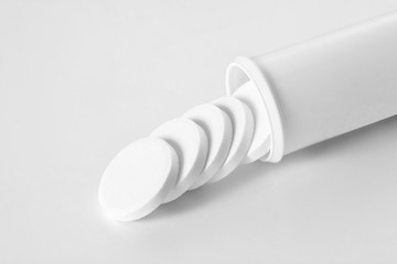 aspirine tablet coming out from its tube isolated on white background with copy space for your text