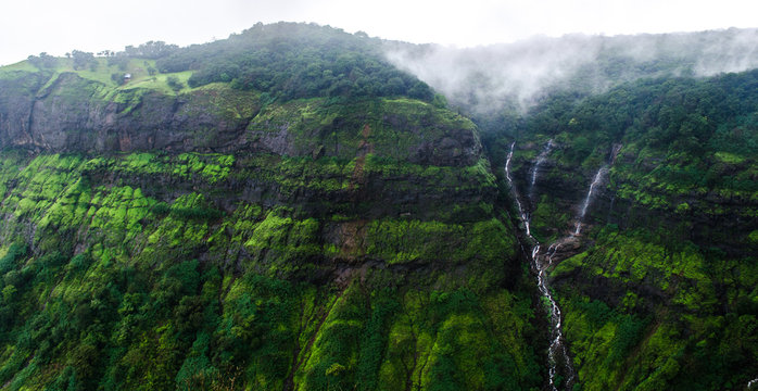Mountain  cliff wtih greenery and cloud in monsoon season