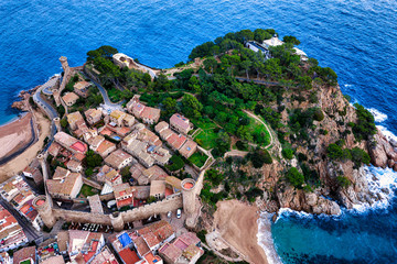 The Spanish city of Tossa de Mar located in Costa Brava is a coastal region of Catalonia. Aerial view. Old city. Mediterranean Sea - 307864710
