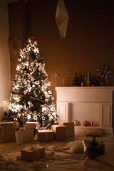 Decorated for the new year interior of the house-the General plan. Christmas tree and decorated Studio, lights garlands, decorations, gift boxes in a cozy home.