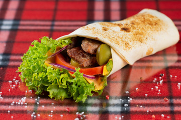 roll with cutlet, fresh vegetables, cheese, chili peppers and cherry tomatoes.