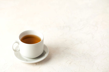 White mug with tea on a light background with a place to enter text.