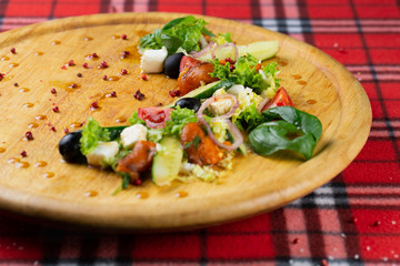 Vegetarian salad of pickled vegetables and cheese. Greek satate with pepper, cucumber, cheese, olives and lettuce seasoned with olive oil