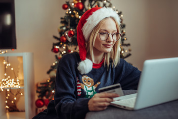 Woman online shopping. Close up of a young woman buying presents online.