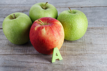 Red and green apple with letter A