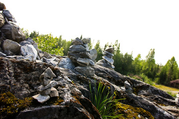 a small pyramid of marble stones on a high mountain covered with moss and lichen, found during a summer walk