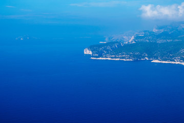 Beautiful sea view with smooth water surface and blue sky. Copy space. Saturated blue color. Colour trend of the year 2020.