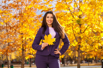 Happy business woman in autumn park