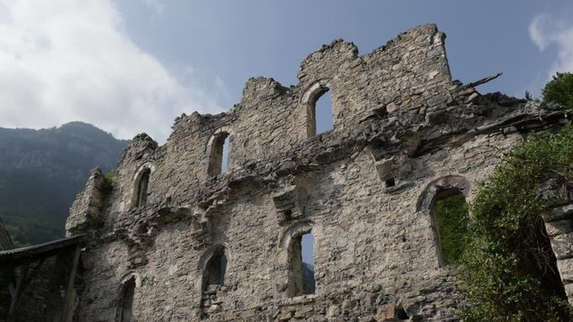 Burned walls of Agios Dionysios monastery on Olympus mountain slow pan 4K video