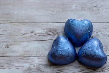 Mug with sugar and chocolate hearts on wood background. Flat lay composition. Romantic, St Valentines Day concept.