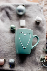 Cup of cocoa with marshmallows on table.