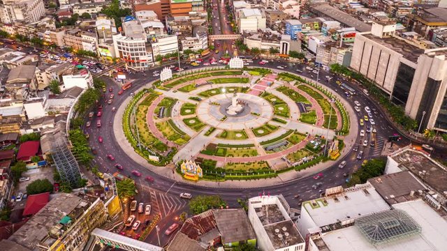 Hyper lapse aerial view shot road roundabout with traffic jam in the evening at Wongwian Yai, Bangkok, Thailand