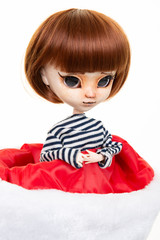 Portrait doll in a red and white christmas cap