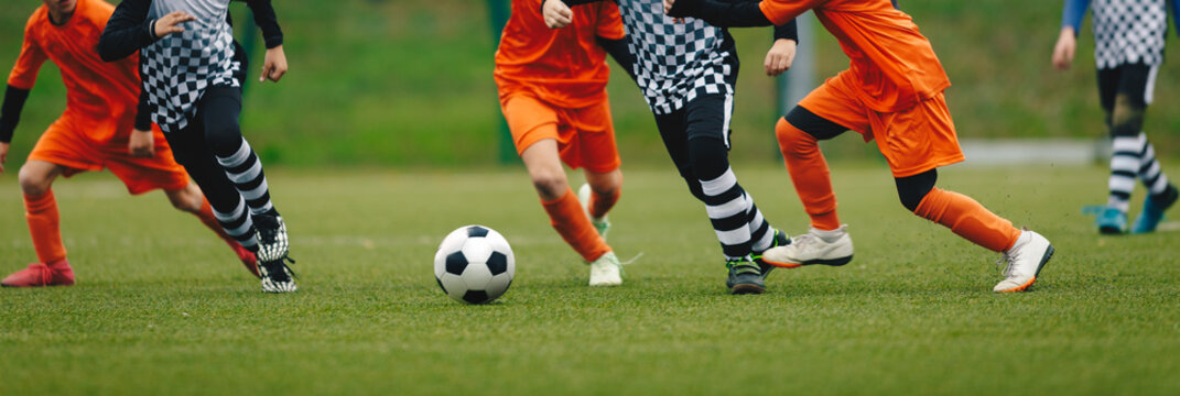 Horizontal Image of Soccer Players Running After Ball and Playing a Football Match