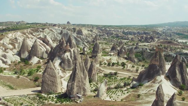 Goreme Rocks, Cappadocia, Love Valley and ridge   volcanic rocks with ancient heritage in Goreme National Park at summer sunny day / Aerial drone view
