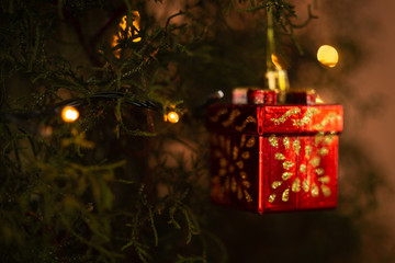 Red and Gold Christmas Gift Ornament Hanging on the Tree
