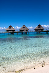 houses over transparent quiet sea water- tropical paradise,