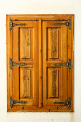 old wooden window in traditional style, isolated on the white wall, selective focus 