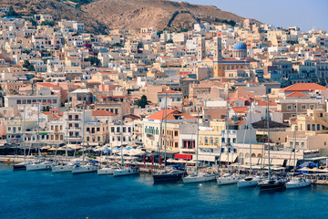SYROS, GREECE - JUNE 26, 2019: casual from city port side streets and building at summer time