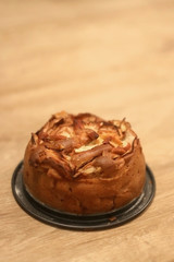 Homemade apple and mascarpone sponge cake, decorated with baked apple slices. Selective focus.