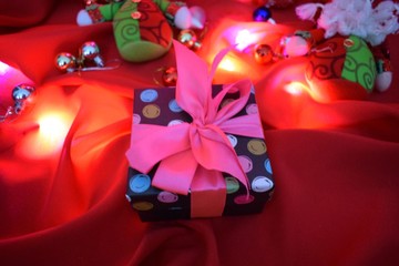gift box with ribbon and bow on red background