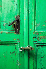 Green, old wooden door with lock, selective focus 