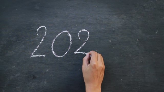 Hand writing 2020 on blackboard, New year and things to do concept.