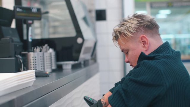 Disabled man gets food in an office restaurant.