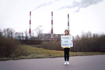 Teenager girl holding placard during global strike for climate change     