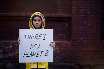 Fototapeta Teenager girl holding placard during global strike for climate change      obraz