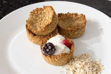 Homemade recipe made with oat flakes and natural yogurt filling, berries. Delicious and healthy breakfast snack preparation