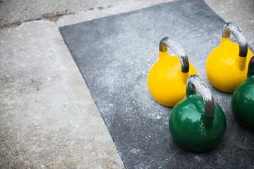 Naklejka na ściany i meble used kettlebell outside on the floor ready for strength and conditioning workout and training