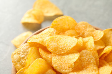 Potato chips. Beer snacks on grey background, space for text. Closeup