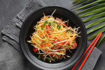 Delicious Som Tam -Thai green papaya salad) with green beans, tomatoes, peanuts. Thai street food . Healthy vegan foodgreen beans, tomatoes, peanuts. Thai street food . Healthy vegan food