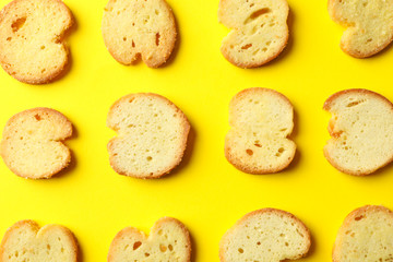 Flat lay with crackers on yellow background, close up