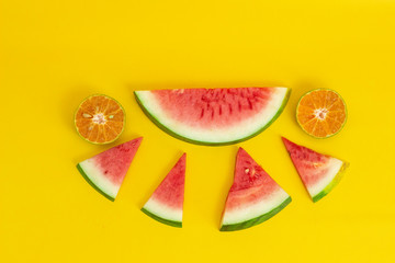 exotic tropical fruits orange, watermelon isolated on a yellow background