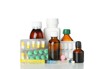 Medical bottles, syringe and pills isolated on white background