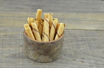 Vanillia waffle roll stick in bowl wooden
