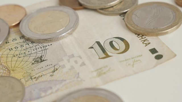 Ten Bulgarian lev banknote and assorted coins shallow DOF 4K video