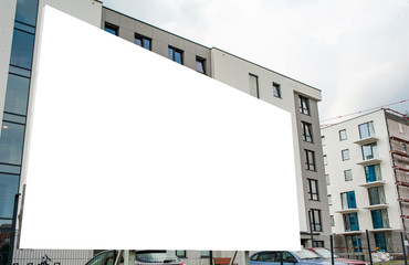 Blank white billboard mockup in the front of modern residential building.