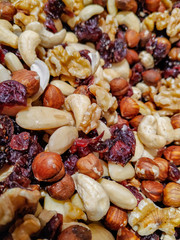 Nutritious and healthy nut mix with dried fruit, made of cashews, almonds, hazelnuts, walnuts, brazil nuts, very colorful, stacked and mixed together to be sold
