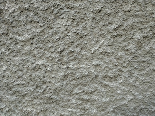 Rough texture of an old brown grey traditional wall with visible pattern of applying the cement and other materials on an old and aged building